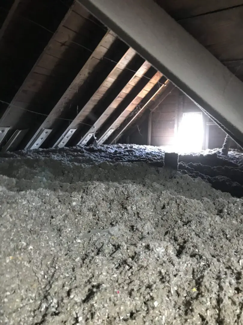 An attic of the house with a material on it.