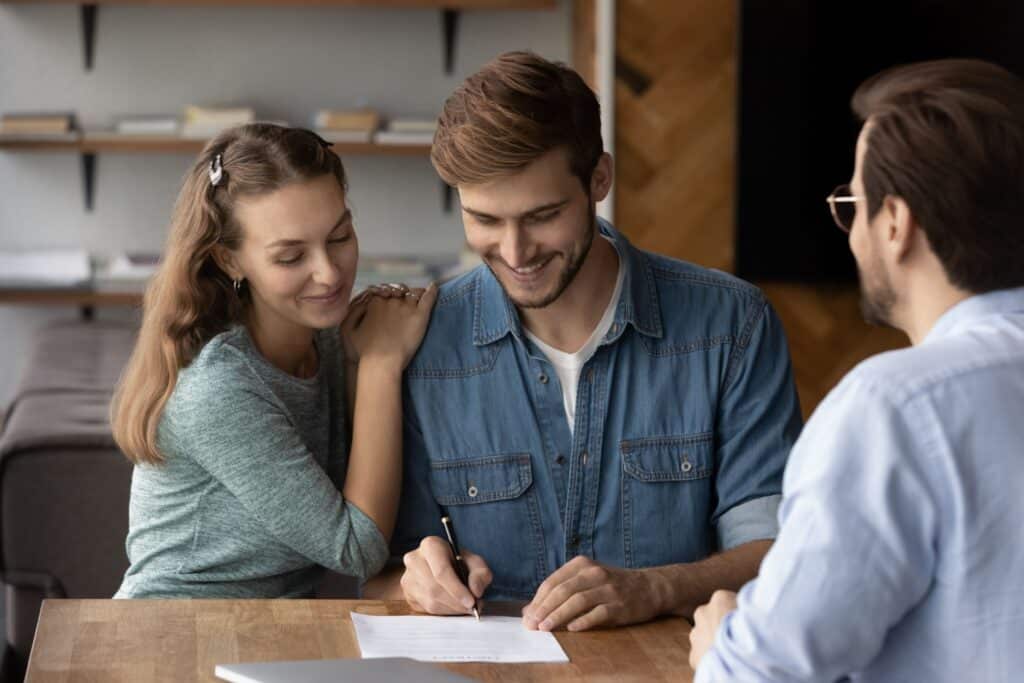 A young couple signing up for a program to improve  their home.