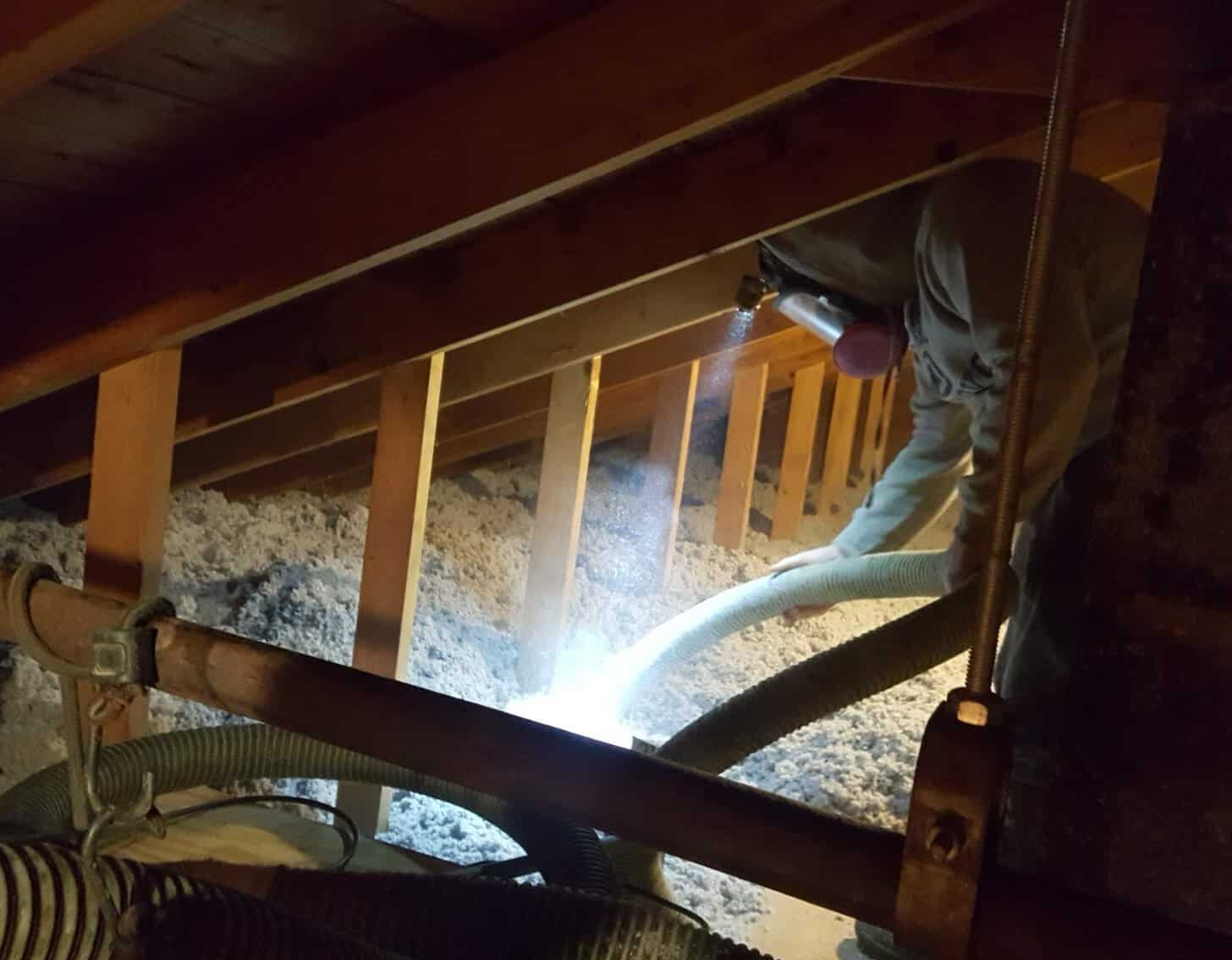 A Sanfilippo's worker in the process of insulating an attic.